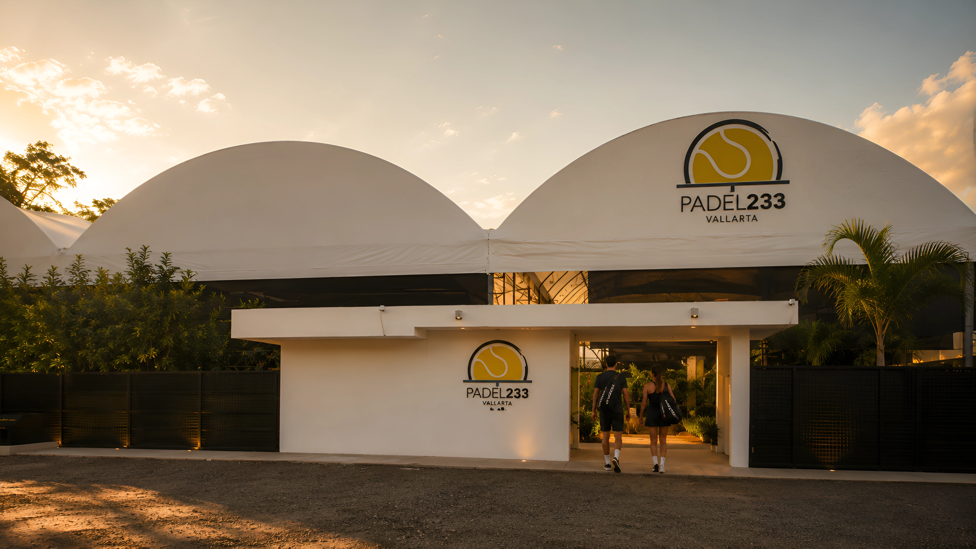 Entrada principal de Padel 233 en Puerto Vallarta al atardecer